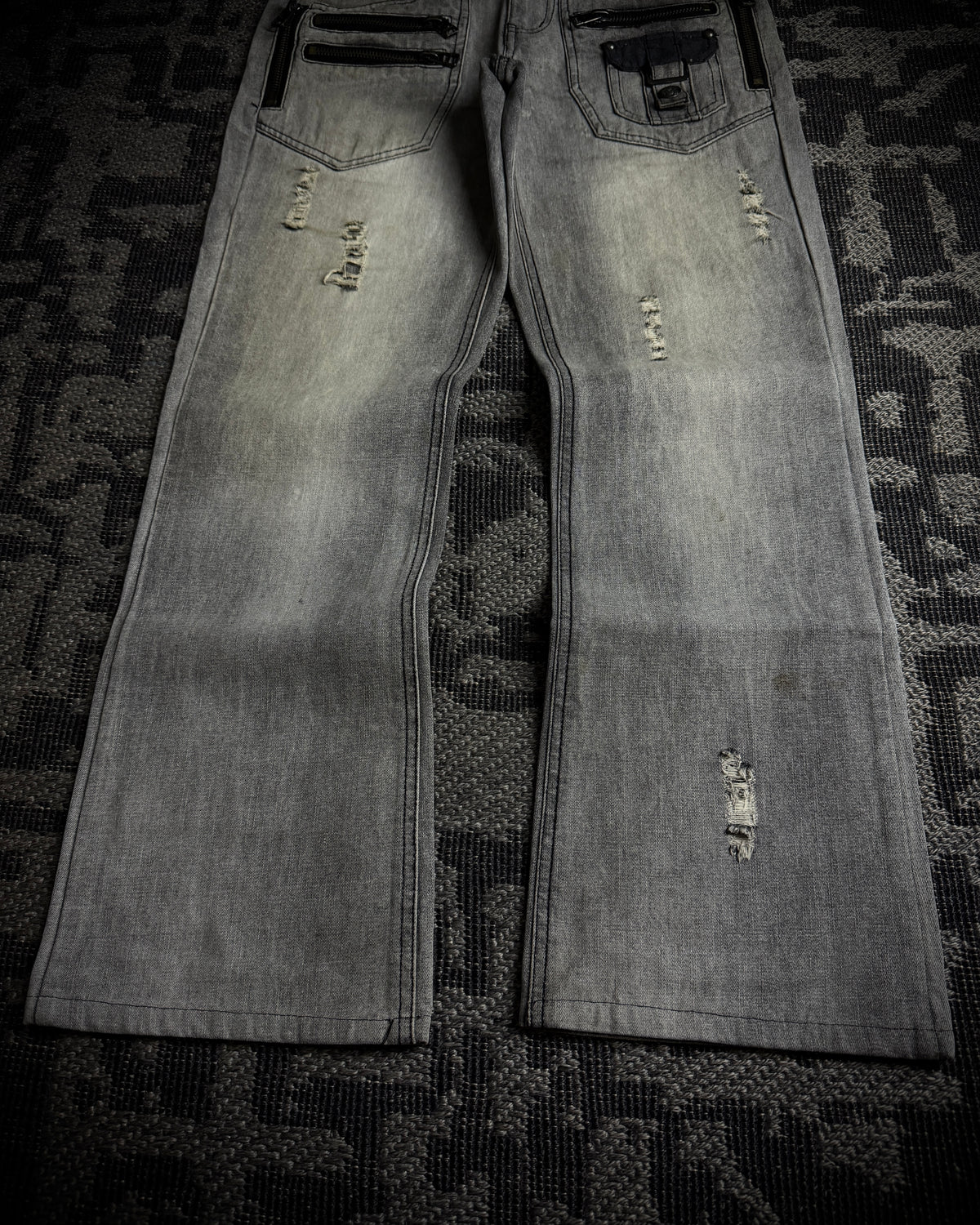 Semantic Design Multi-Zip Distressed Boot Cut Jeans